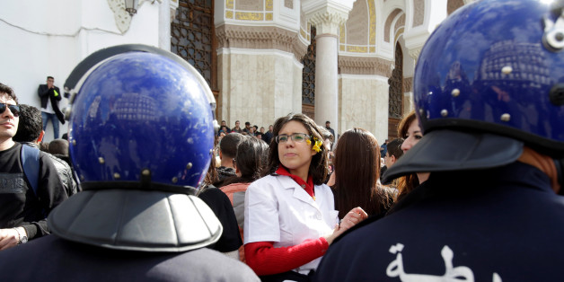 Riot police stand guard in front of Algerian doctors, who are completing their residency stage of their studies, holding a sit-in protest in Algiers Algeria , February 12, 2018. Picture taken February 12, 2018. REUTERS/Ramzi Boudina