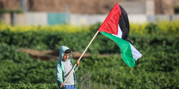 GAZA CITY, GAZA - FEBRUARY 23: A Palestinian child holds a Palestinian flag during a protest against U.S. President Donald Trumps announcement to recognize Jerusalem as the capital of Israel, in Shuja'iyya neighborhood of Gaza City, Gaza on February 23, 2018. (Photo by Ali Jadallah/Anadolu Agency/Getty Images)