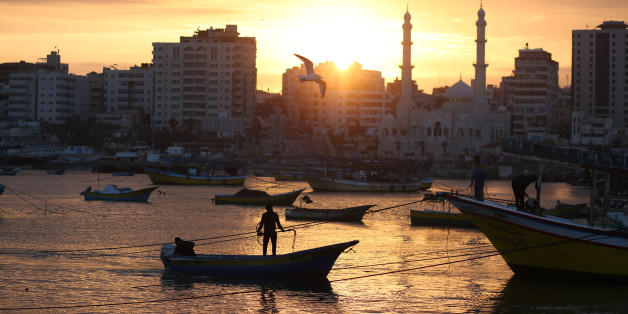 Palestinian fishermen work on their fishing boats at the sea port of Gaza City on January 25, 2018. (Photo by Majdi Fathi/NurPhoto via Getty Images)