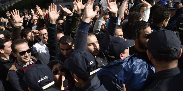 Algerian anti riot police surround doctors and dentists who are completing their residency stage of their studies during a sit-in outside La Grande Poste in the capital Algiers, on February 12, 2018, as part of a three-month-long strike protesting against compulsory civil service. / AFP PHOTO / RYAD KRAMDI (Photo credit should read RYAD KRAMDI/AFP/Getty Images)