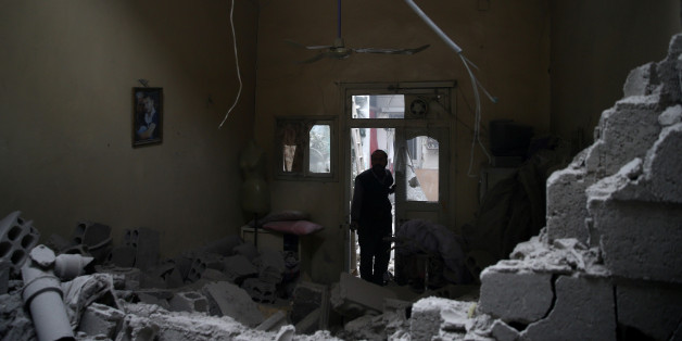 A man inspects a damaged house in the besieged town of Douma in eastern Ghouta in Damascus, Syria, February 22, 2018. REUTERS/Bassam Khabieh