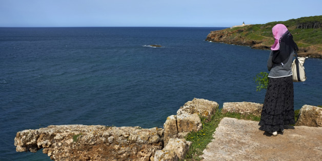 An Algerian woman looks out to the sea as she visits a Roman ruin at the Tipasa archaeological UNESCO World Heritage site, some 70 km (43 miles) west of Algiers, May 4, 2012. REUTERS/Zohra Bensemra (ALGERIA - Tags: SOCIETY TRAVEL)