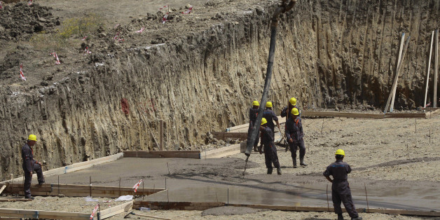Labourers work at a residential construction site in Ain Benian on the outskirts of the Algerian capital Algiers, July 2, 2013. Political and social pressures are combining to open Algeria's construction market to international competition, potentially making billion of dollars worth of contracts available to foreign companies. Housing supply has long been a source of public discontent in Algeria, which has a young and growing population of 37 million. Migration to the cities has packed some ext
