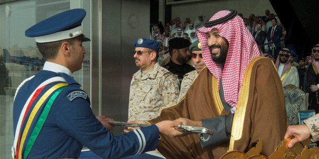 A cadet of King Faisal Air Academy receives a sword from Saudi Arabia's Crown Prince Mohammed bin Salman during a graduation ceremony in Riyadh, Saudi Arabia, February 21, 2018. Bandar Algaloud/Courtesy of Saudi Royal Court/Handout via REUTERS ATTENTION EDITORS - THIS PICTURE WAS PROVIDED BY A THIRD PARTY.