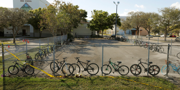 Bicycles used to go to school on the day of the shooting at Marjory Stoneman Douglas High School remain on campus four days after the event in Parkland, Florida, U.S. February 18, 2018. REUTERS/Jonathan Drake