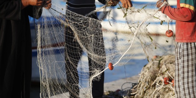 Djerba fishermen tending nets, Tunisia. (Photo by: Godong/UIG via Getty Images)