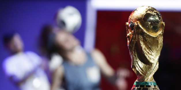 Participants perform near the World Cup trophy during the "Behind the scenes of the Final Draw" event prior to the upcoming Final Draw of the 2018 FIFA World Cup Russia in Moscow, Russia November 29, 2017. REUTERS/Sergei Karpukhin