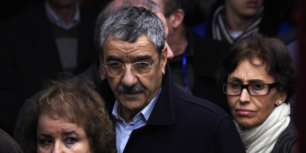 Said Sadi (C), head of the opposition Rally for Culture and Democracy (RCD) pays tribute next to the coffin of late Algerian opposition figure Hocine Ait-Ahmed, on December 31, 2015 in the capital Algiers, after his body was brought to his homeland for a state funeral. Ait-Ahmed, one of the fathers of Algeria's struggle for independence from France and then a longtime opposition figure, died in Lausanne, Switzerland on December 23, his Socialist Forces Front party said. Ait-Ahmed, 89, was the la