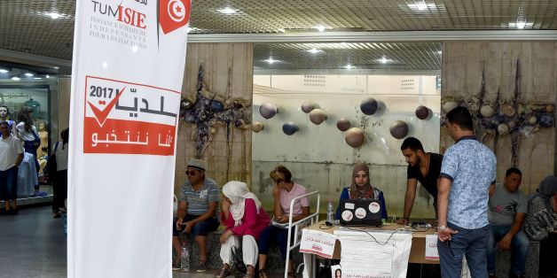 A picture taken on August 4, 2017 shows employees of the Tunisian ISIE elections body sitting at an outreach booth at a shopping mall in the capital Tunis, in a bid to encourage citizens to register to vote in the upcoming municipal elections, due in December 2017. / AFP PHOTO / FETHI BELAID (Photo credit should read FETHI BELAID/AFP/Getty Images)