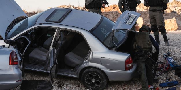 Israeli security forces inspect a Palestinian motor vehicle at the Qalandiya checkpoint, between Ramallah and Jerusalem, in the occupied West Bank, on August 2, 2017. / AFP PHOTO / Ahmad GHARABLI (Photo credit should read AHMAD GHARABLI/AFP/Getty Images)