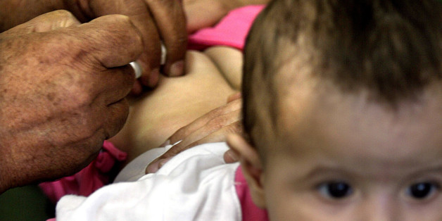 An Iraqi baby is given an injection in a health centre in the capital
of Baghdad June 22, 2003 as the ministry of health and UNICEF launched
National Immunization Day. Iraq's 4.2 million children under the age of
five have started to be innoculated against preventable diseases such
as polio, tetanus, diptheria, pertussis, measles and tuberculosis.
REUTERS/Faleh Kheiber
CLH/CRB