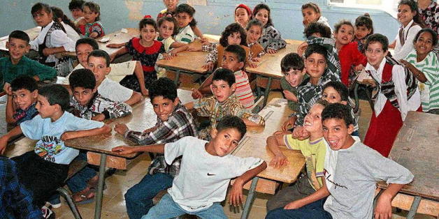 BOUFARIK, ALGERIA: Algerian schoolchildren attend 09 September their first day of the school year in the city of Boufarik, 35 kms (20 miles) south of the capital Algiers. But the first day of school was not observed in the Algiers suburbs of Beni Messous, where 63 people were killed overnight 05 September, nor in Rais, where 98 people were slain last week. (Photo credit should read AFP/Getty Images)