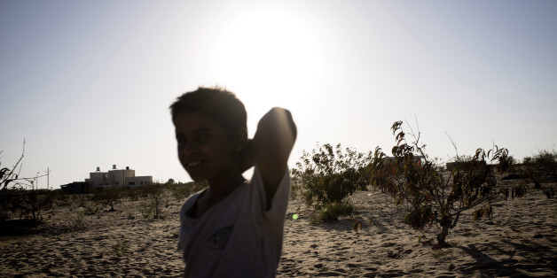 EL ARISH, EGYPT - SEPTEMBER 20: An Egyptian bedouin boy walks through a field in the village of Al Muqattah, in Egypt's restive North Sinai region, September 20, 2012. The village of Al Muqattah lies in Egypt's North Sinai desert, less than 10km from the Israel-Egypt border. The area is at the centre of 'Operation Eagle, an effort by Egyptian security forces, reportedly with the assistance of Israeli intelligence, to establish security in North Sinai and rid the area of Islamic militants held re