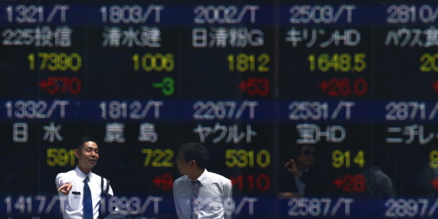 Men are refelcted in a screen displaying market indices outside a brokerage in Tokyo, Japan April 19, 2016. Japan's Nikkei share average soared on Tuesday morning, as a weak yen and a bounce in oil prices helped the market erase a sharp drop from the previous day. REUTERS/Thomas Peter