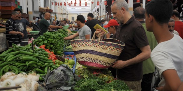 Tunisians look at vegetables displayed on a stall at the central market in Tunis, on June 29, 2014 on the first day of the holy fasting month of Ramadan. Ramadan is sacred to Muslims because it is during that month that tradition says the Koran was revealed to the Prophet Mohammed. AFP PHOTO / FETHI BELAID (Photo credit should read FETHI BELAID/AFP/Getty Images)