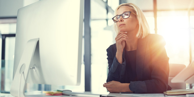 Shot of a thoughtful businesswoman working at her desk in a modern office