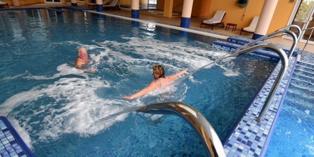 Tourists swim under the jets inside a swimming pool in the Imperial Merhaba Hotel in Port el-Kantaoui, on the outskirts of Sousse south of the capital Tunis on April 21, 2017.The hotel at the resort of Port El Kantaoui near Sousse reopened this week, rebranded the 'Kantaoui Bay', after it remained closed for two years following an attack by a Tunisian gunman which was claimed by the Islamic State (IS) group. The gunman, Seifeddine Rezgui, shot dead 38 tourists -- including 30 Britons -- on June