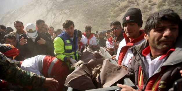 CHAHARMAHAL AND BAKHIARI, IRAN - MARCH 12: Rescue workers carry a body bag with a victim at the crash site of a private Turkish aircraft in Kiyar district of Chaharmahal and Bakhtiari Province of Iran on March 12, 2018. A private Turkish aircraft, with 11 people on board, crashed in southwestern Iran. Everyone on board reportedly died in the crash. (Photo by Ali Reza Motamedi/Anadolu Agency/Getty Images)