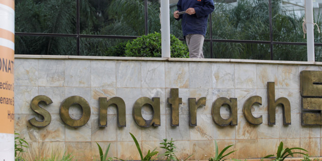 An employee stands near the headquarter building of the state energy company Sonatrach in Algiers, Algeria june 26, 2016.Reuters/Ramzi Boudia