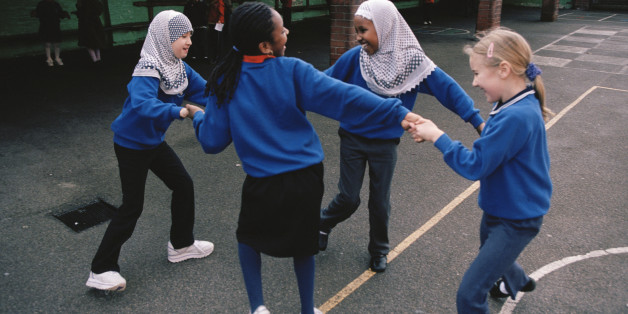 (Original Caption) Girls enjoying themselves on the playground of Melcombe Primary School, a formerly failing inner-city school, which has been transformed by the work of a new head and dedicated senior management. Many of the students come from backgrounds which could present educational challenges, such as refugee status, non native English speaking homes and children in temporary accommodation. Staff successfully address these issues and the school has become a government 'beacon' school.