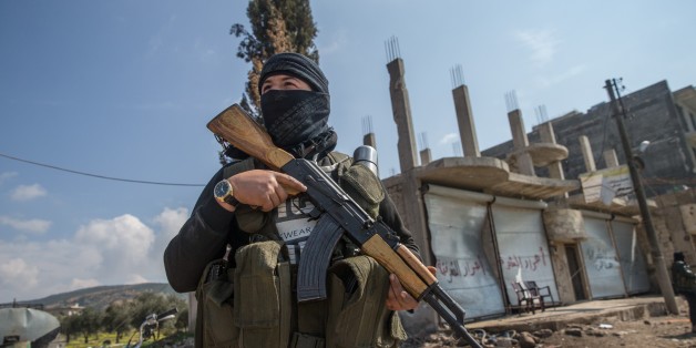 AFRIN, SYRIA - MARCH 13: A member of Free Syrian Army, backed by Turkish Armed Forces is seen as he stands guard at Rajos town center after they took control the Rajos town center from YPG/ PYD /PKK-Daesh terrorists during the Operation Olive Branch in Syrias northwestern Afrin region on March 13, 2018. Turkey launched Operation Olive Branch on January 20 in Syrias northwestern Afrin region; the aim of the operation is to establish security and stability along Turkish borders and the region as well as to eliminate PKK/KCK/PYD-YPG and Daesh terror groups, and protect the Syrian people from the oppression and cruelty of terrorists. (Photo by Halil Fidan/Anadolu Agency/Getty Images)