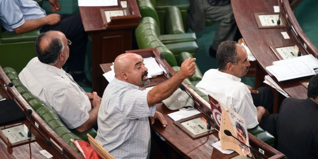 Tunisian MP Brahim Gassas gestures during a plenary session of the Constituent Assembly due to set an election calendar on June 25, 2014 in the capital Tunis. After months of negotiations among Tunisia's political parties, Tunisia's National Assembly approved October 26 for the legislative election and November 23 for the presidential poll, as it was proposed by the electoral commission. AFP PHOTO / FETHI BELAID (Photo credit should read FETHI BELAID/AFP/Getty Images)