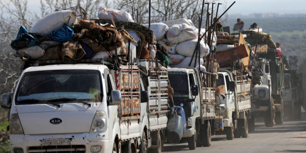 People ride on trucks with their belongings in north-east Afrin, Syria March 13, 2018. REUTERS/Khalil Ashawi