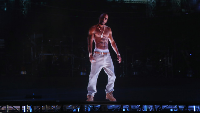 INDIO, CA - APRIL 15: A hologram of deceased rapper Tupac Shakur performs onstage during day 3 of the 2012 Coachella Valley Music & Arts Festival at the Empire Polo Field on April 15, 2012 in Indio, California. (Photo by Christopher Polk/Getty Images for Coachella)