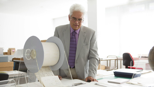 In this handout photograph, author Ray Waru inspects files at New Zealand's national archives in Wellington following the release of his new book, "Secrets and Treasures." The book reveals information about rare historical gems buried in New Zealand's national archives, including a bizarre WWII plan to create a "tsunami bomb" and military X-Files detailing supposed UFO sightings. (AFP PHOTO / David Sanderson / manipula.co.nz)
